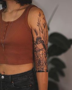 a woman with a bird tattoo on her arm