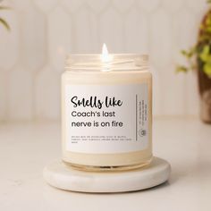 a candle that says smells like coach's last never is on fire