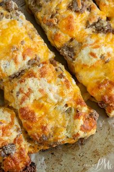 cheesy meat and cheese bread sticks on a baking sheet, ready to be eaten