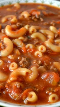 a white bowl filled with pasta and meat soup