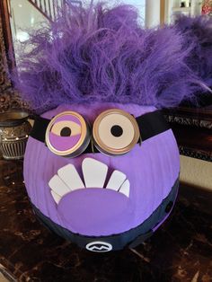 an odd looking purple object with eyes and hair