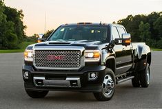 a black truck is parked on the street