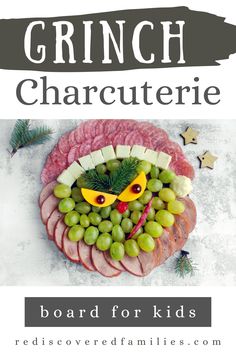 a plate with grapes, meat and cheese on it that says grin charcuterie board for kids