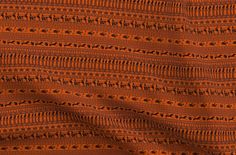 an orange and black pattern on fabric