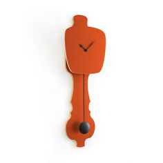 an orange clock with black hands on a white wall