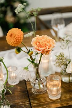 there are many vases with flowers in them on the table