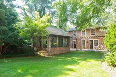 the back yard has grass and trees around it, as well as a gazebo