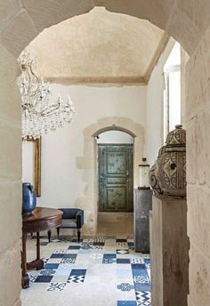 an image of a hallway with a chandelier hanging from it's ceiling