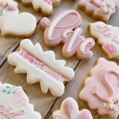 decorated cookies are arranged on a wooden table