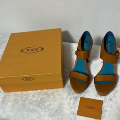 Authentic Tod’s Leather Heels. Designed Using Calf Leather, This Pair Of Tod's Sandals Exudes Luxury And Style. They Feature Open Toes And Closed Backs With Buckle Fastening At The Ankles. Chunky Heels, Platform In Front, And Leather Insoles Complete The Pair Beautifully. Comes In Original Box With Dust Cover. New And Never Worn, In Original Condition. Original Sales Tag On Bottom Of Heel. Please Review Pictures To See The Variations In The Leather. Beautiful Brandy Color. High Heel Sandals Platform, Wingtip Oxford Shoes, Tods Shoes, Tan Shoes, Heels Platform, Sandal Platform, Platform Loafers, Brown Leather Sandals, Black Leather Sandals