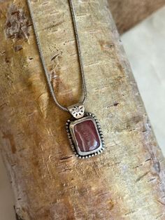 Rhodochrosite stone bezel set in sterling silver with silver plated chain to match. Clasp closure. Handmade with love Sterling Silver Square Pendant With Natural Stones, Silver Necklace With Rectangular Gemstone, Artisan Sterling Silver Rectangular Necklace, Silver Jewelry With Large Rectangular Stone, Silver Sterling Silver Necklace With Rectangular Stone, Silver Necklace With Rectangular Stone For Gift, Silver Rhodonite Jewelry With Natural Stones, Rhodonite Gemstone Jewelry For Gift, Sterling Silver Cabochon Rectangular Pendant