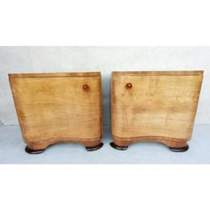 two wooden nightstands sitting next to each other on top of a white flooring