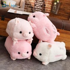 three stuffed pigs sitting next to each other