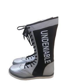 a pair of silver and black boots with the words unevenancee on them