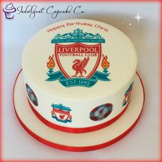 a birthday cake with the liverpool football club logo on it's frosting and red trim