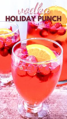 two glasses filled with red liquid and lemon slices