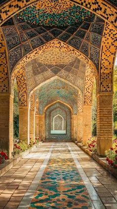 an ornate archway in the middle of a building with many flowers growing on either side