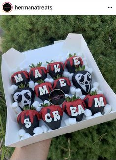 a box filled with chocolate covered strawberries that say make me scream and panda faces