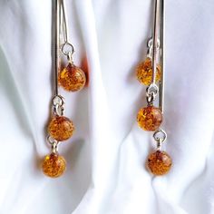 MORE AMBER EARRINGS - https://www.etsy.com/ie/shop/PreciousAmber?ref=seller-platform-mcnav§ion_id=19068095  Nature and beauty combined with a playful pair of  Amber ear candies. Flawlessly crafted honey Baltic Amber dainty beads set in 925 Hallmarked Silver. Lever back, or push-back closure ensures secure and carefree wear. Handcrafted to perfection will make a meaningful nature-inspired gift or a wonderful love token for yourself or your special someone. Comes beautifully presented in our signa Long Earring, Love Token, Amber Earrings, Luxury Gift Box, Amber Jewelry, Resin Beads, Baltic Amber, Jewelry Gift Box, Long Earrings