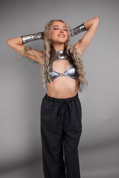 🚀✨ Step into the future with this stunning silver metallic crop top. Perfect for rave outfits and music festivals, its unique cutout design and high-shine finish make a bold fashion statement. Pair it with sleek black pants for a chic and edgy look that's out of this world. #FuturisticFashion #RaveOutfit #MusicFestivalStyle #MetallicTrend #BoldStyle #EdgyChic Silver Crop Top, Metallic Crop Top, Rave Gear, Music Festival Fashion, Futuristic Style, Edgy Chic, Cutout Design, Futuristic Fashion, Into The Future