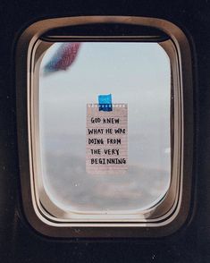 an airplane window with a message written on it