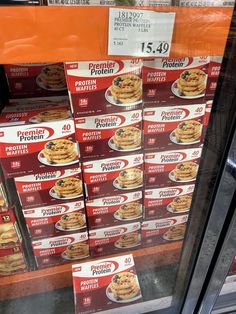 boxes of protein protein pancakes on display for sale in a grocery store's window