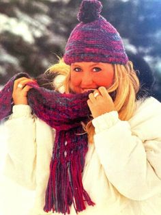 a woman wearing a purple hat and scarf