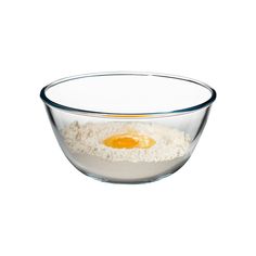 an egg is in a glass bowl on a white background