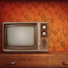 an old tv sitting on top of a wooden table next to a wall with the words lonetards written on it