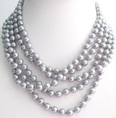 "Silver Gray Pearl 100 inches long necklace with hand knotted after each pearl Multi Strand Pearl Necklace, Statement Bridal Pearl Jewelry, Hand Knotted Pearls This lovely pearl necklace has been hand knotted with Silver Gray silk thread and is finished off with a gorgeous quality Both elegant and feminine. Pearls are the perfect choice for any occasion. Pearls flatter the complexion beautiful necklace Multi Strand or 2 or 3 or 4 5 or strand Necklace : 100 Inches long Click on fashionjewelryfore Bridal Pearl Jewelry, Hand Knotted Pearls, Multi Strand Pearl Necklace, White Pearl Jewelry, Grey Pearl Necklace, Gray Necklace, Pearl Statement Necklace, Pearl Bridal Jewelry, Long Pearl Necklaces