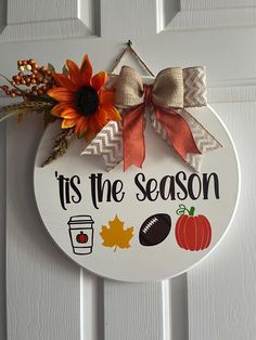 a sign that says it's the season with fall decorations