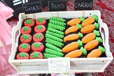 there are many carrots and tomatoes on display in the box for everyone to see