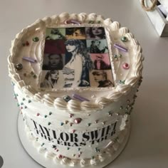 a white cake decorated with photos and confetti