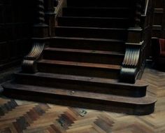 an old wooden stair case in a dark room