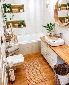 a bathroom with wooden floors, white walls and wood flooring on the counter top