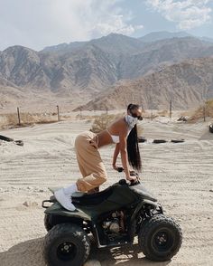 a man riding on the back of an atv