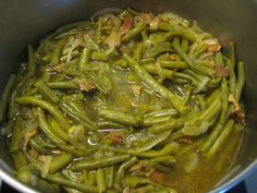 green beans and bacon cooking in a pot on the stove