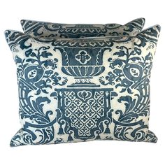 two blue and white pillows with decorative designs