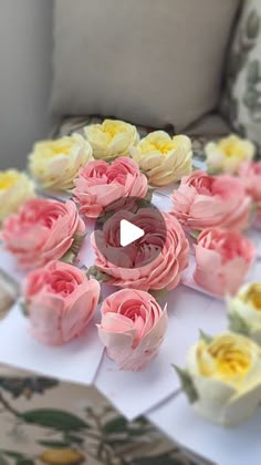 a table topped with lots of pink and yellow flowers