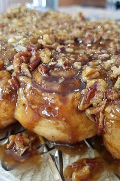 a close up of some kind of food on a glass plate with pecans and nuts