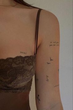 a woman's arm with tattoos on it, and the words love are written in cursive writing