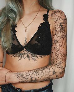 a woman with tattoos on her arms and chest