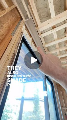 a man is pointing at the window in his house that's being built into the ceiling