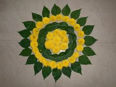 yellow flowers arranged in a circle with green leaves on the bottom and center, against a gray background