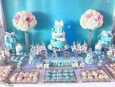 a dessert table with blue and white decorations