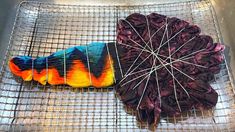 a colorful object sitting on top of a metal grate next to a piece of cloth