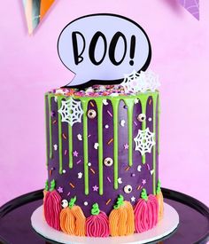 a halloween themed cake with sprinkles and boo on top, sitting on a plate