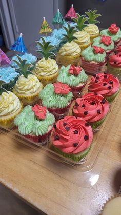 cupcakes are lined up on a table