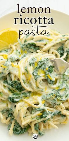 lemon ricotta pasta with spinach and parmesan cheese on a white plate