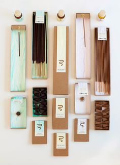 an assortment of chocolates and matchsticks are arranged on a table with labels